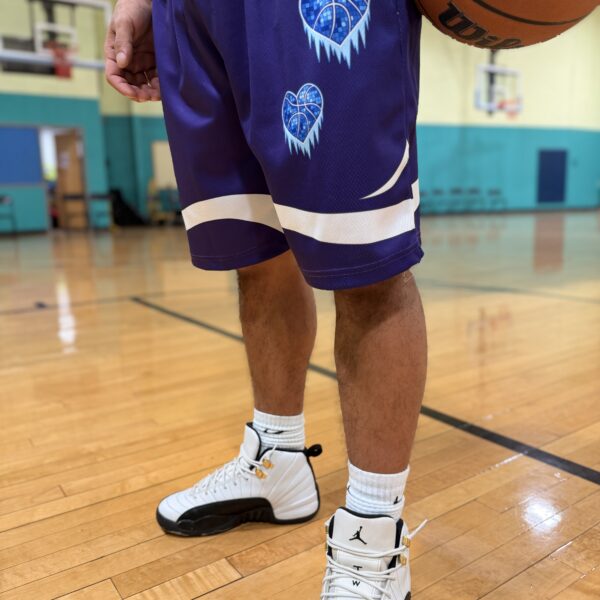 Basketball player wearing black and white sneakers on court.